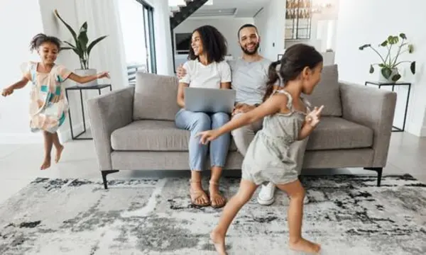 Happy family relaxing at home after lowering monthly payments with a HELOC