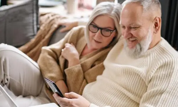 Couple reviewing their finances together after consolidating high-interest debt
